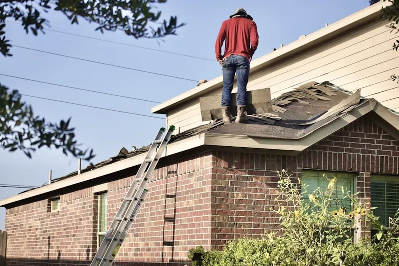 Professional roofer working on a residential roof in Cape Elizabeth